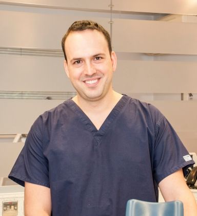 Angel Ognemirov, endodontist treating patients from Nuneaton, in clinical scrubs